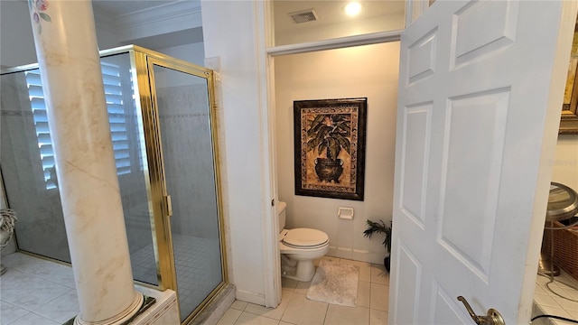 bathroom featuring toilet, a shower with door, crown molding, tile floors, and ornate columns