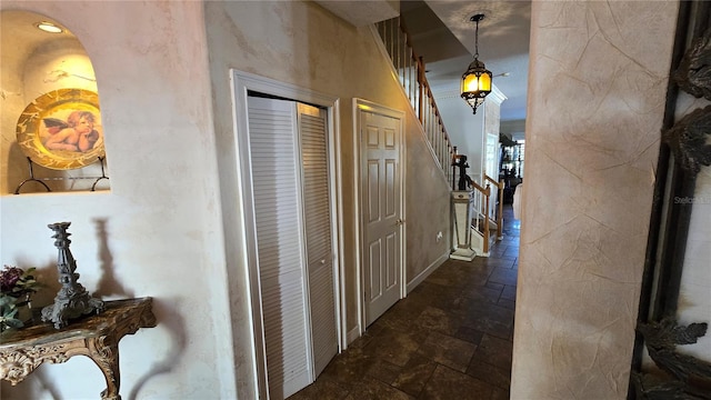 corridor with dark tile floors