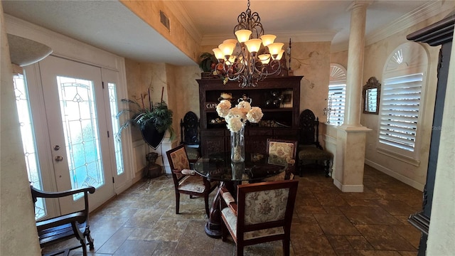 tiled dining area with an inviting chandelier, decorative columns, and ornamental molding