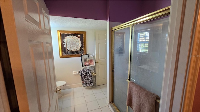 bathroom with tile floors, a shower with shower door, and toilet