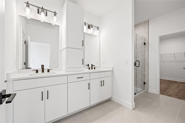 bathroom featuring vanity, tile patterned floors, and a shower with door