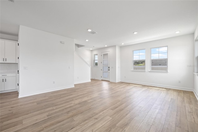 unfurnished living room with light wood-type flooring