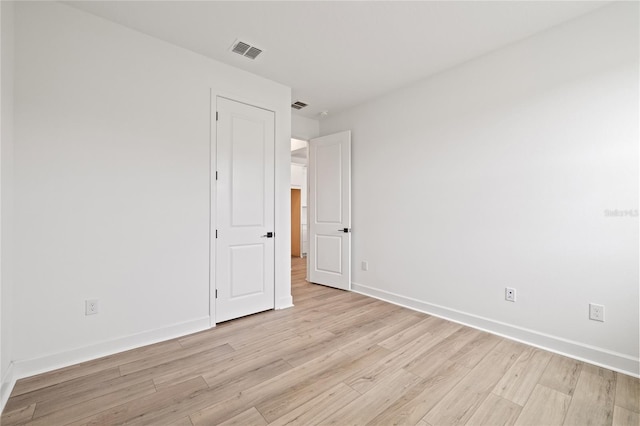 unfurnished room with light hardwood / wood-style floors