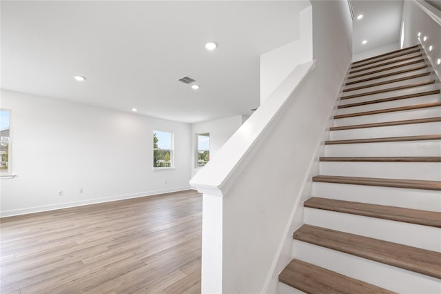 staircase with hardwood / wood-style floors