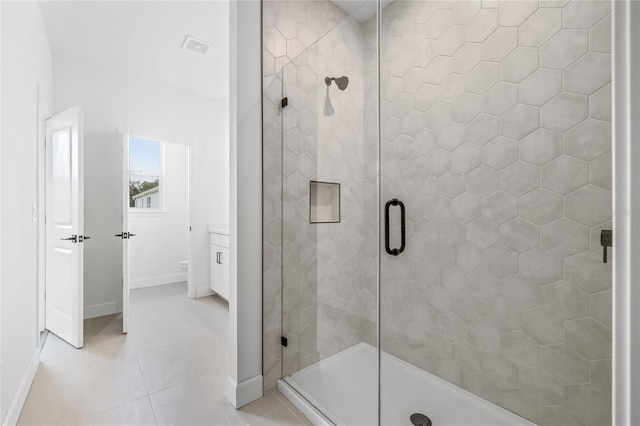 bathroom with vanity, an enclosed shower, and tile patterned floors