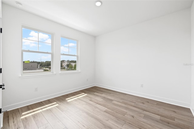 empty room with light hardwood / wood-style floors