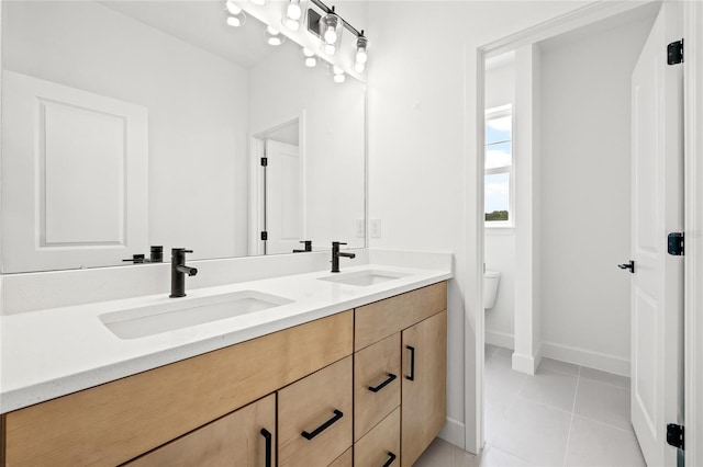 bathroom with vanity, toilet, and tile patterned floors