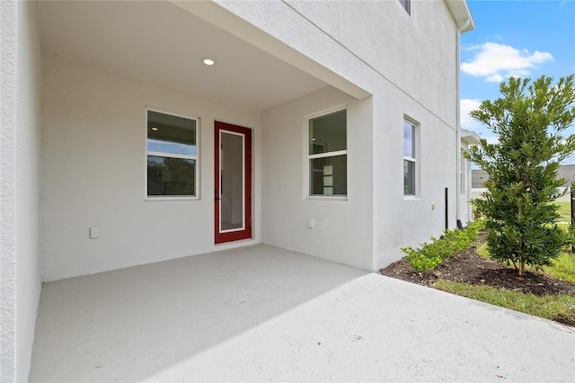 property entrance featuring a patio area