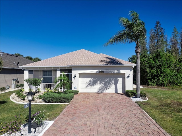 ranch-style house featuring a front lawn and a garage