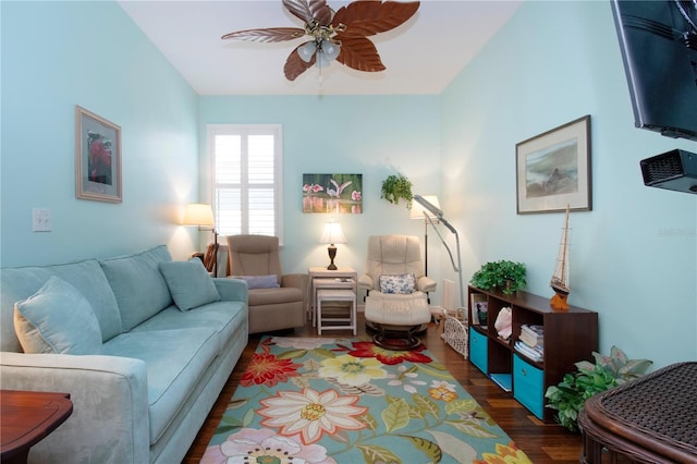 living room featuring ceiling fan and dark wood-type flooring