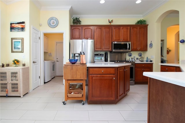 kitchen featuring ornamental molding, appliances with stainless steel finishes, and light tile floors