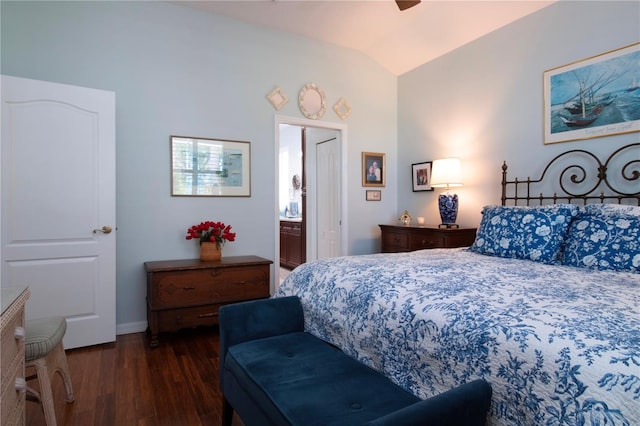 bedroom featuring lofted ceiling, ceiling fan, ensuite bath, and dark wood-type flooring