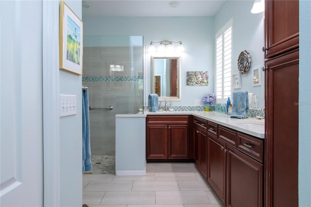 bathroom with double sink vanity, tile floors, and tiled shower