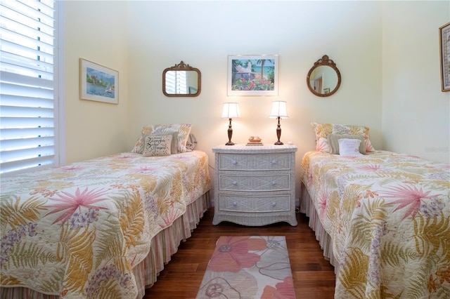 bedroom with dark hardwood / wood-style floors