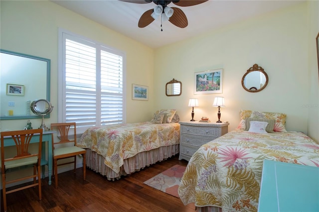 bedroom with dark hardwood / wood-style flooring and ceiling fan