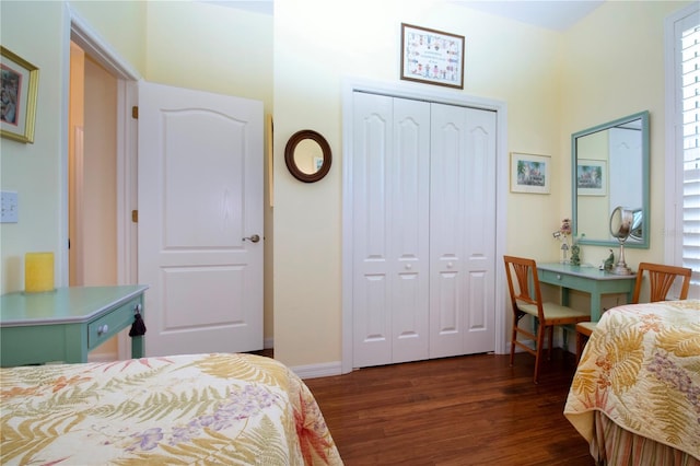 bedroom with a closet and dark hardwood / wood-style floors