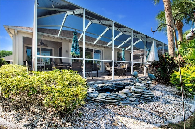 rear view of property featuring a lanai and a patio area