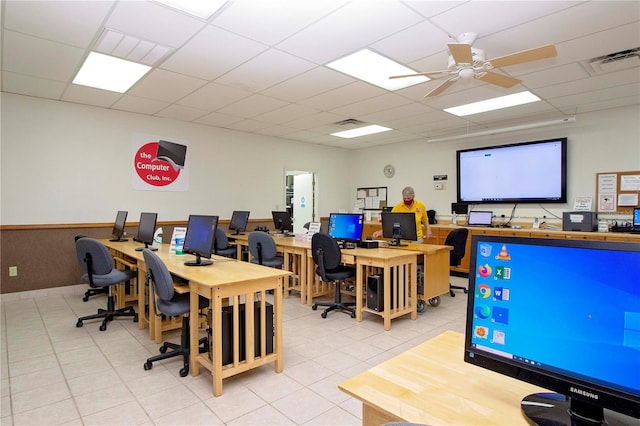 office area featuring light tile floors, ceiling fan, and a drop ceiling