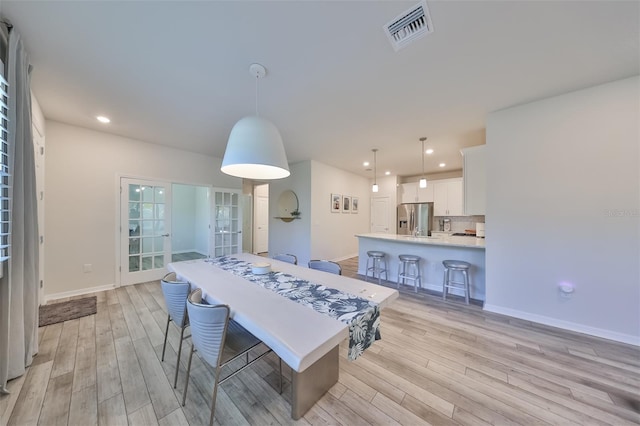 dining room with light hardwood / wood-style floors