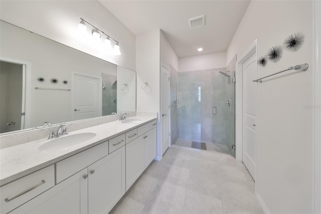 bathroom featuring walk in shower, tile floors, and dual bowl vanity