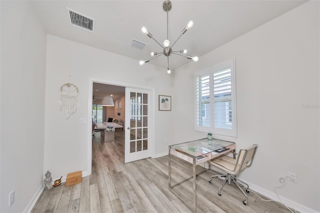 office featuring a chandelier and light hardwood / wood-style floors