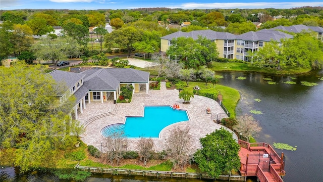 view of pool featuring a water view and a patio area