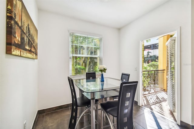 dining area with dark tile floors