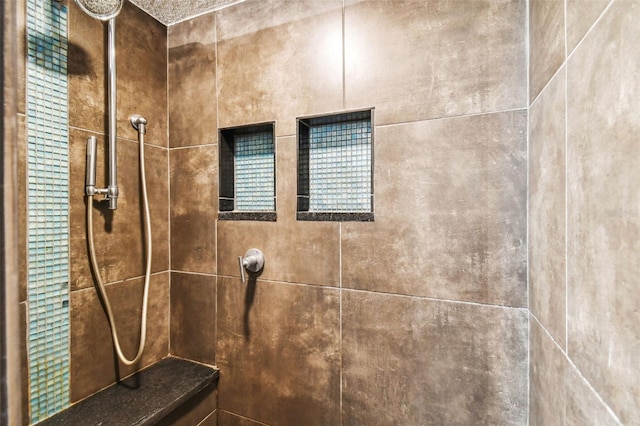 interior details featuring tiled shower