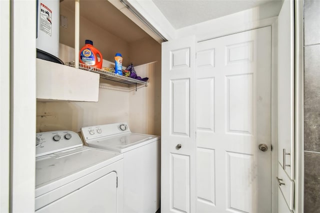 laundry area featuring water heater and washing machine and dryer