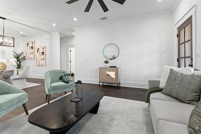 living room with ornamental molding, ceiling fan with notable chandelier, and hardwood / wood-style flooring