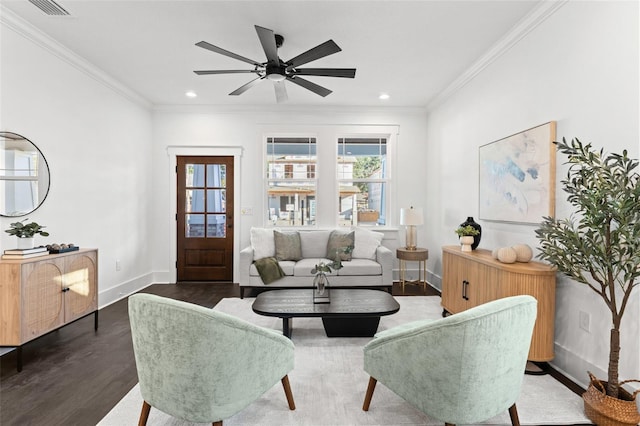 living room featuring ceiling fan, dark hardwood / wood-style flooring, and crown molding