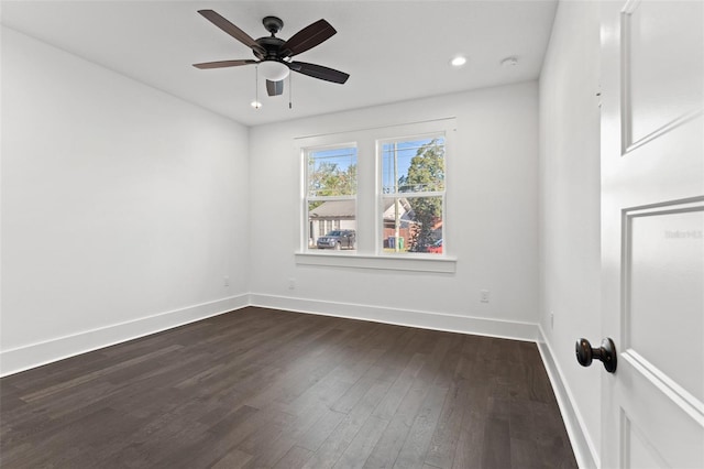 empty room featuring ceiling fan and dark hardwood / wood-style floors