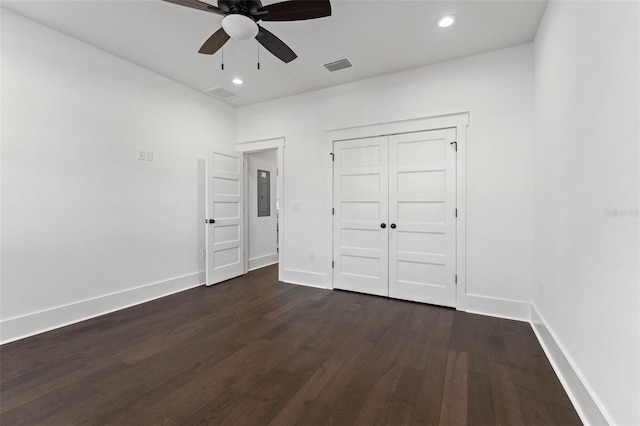 unfurnished bedroom with a closet, ceiling fan, and dark hardwood / wood-style flooring