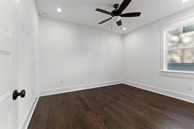 empty room with dark hardwood / wood-style floors and ceiling fan