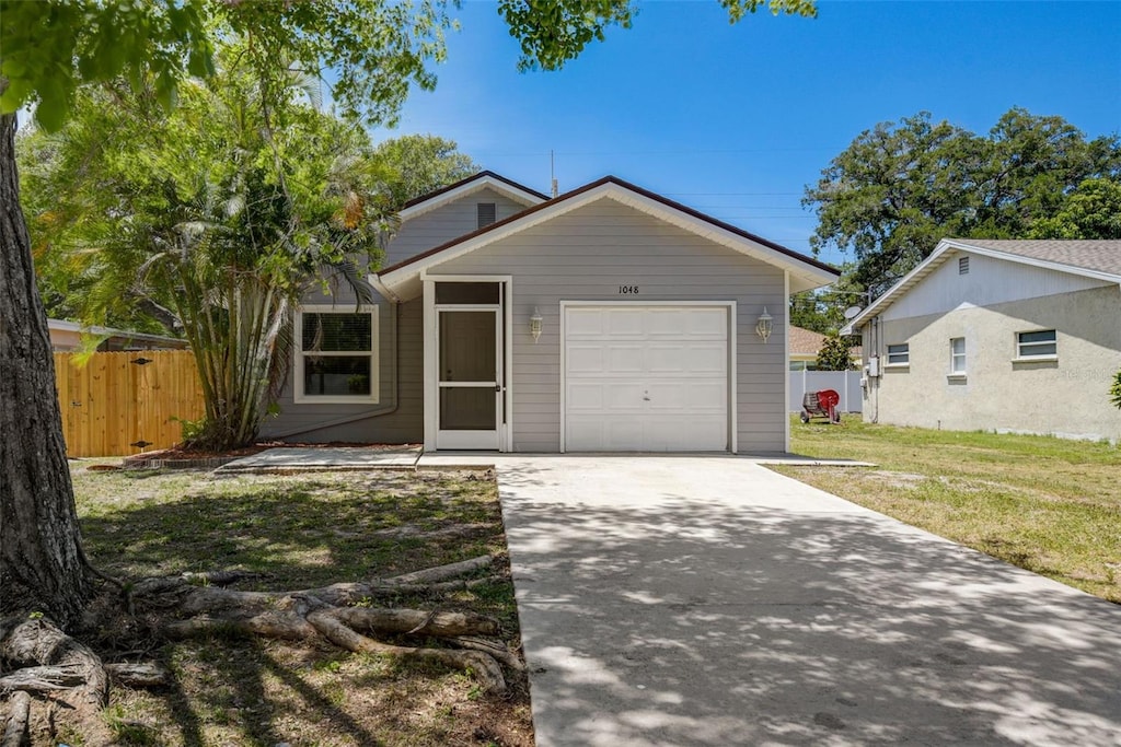 view of front facade with a front yard and a garage