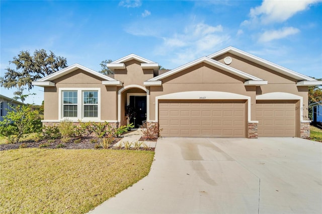 view of front of property with a front yard and a garage