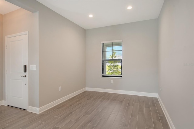 empty room with light hardwood / wood-style flooring