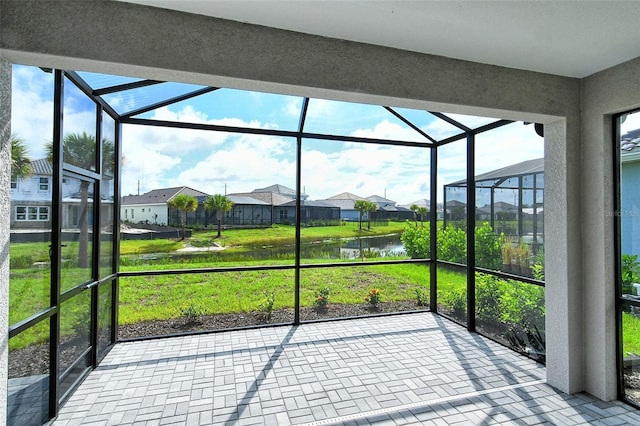 unfurnished sunroom with a water view