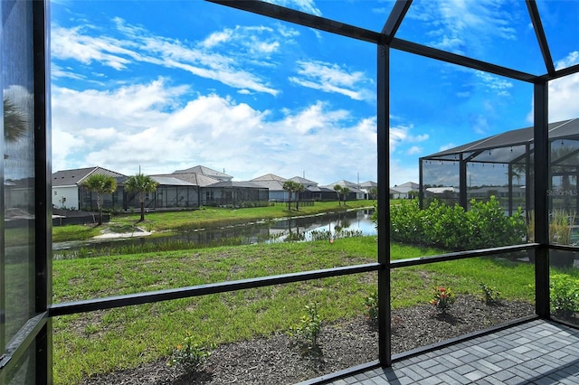 unfurnished sunroom featuring a water view