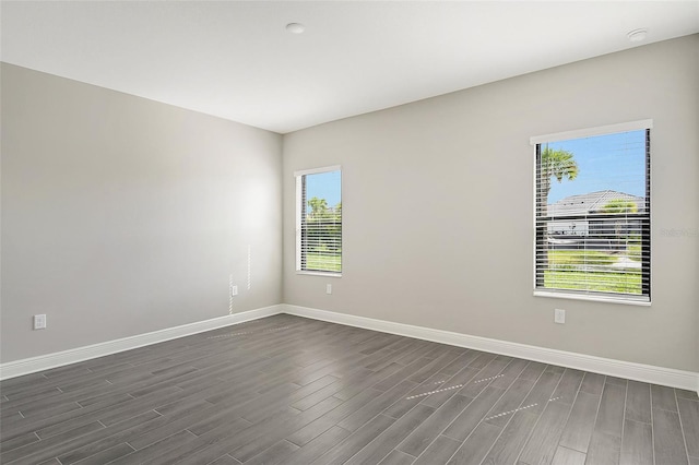 unfurnished room featuring dark wood-type flooring