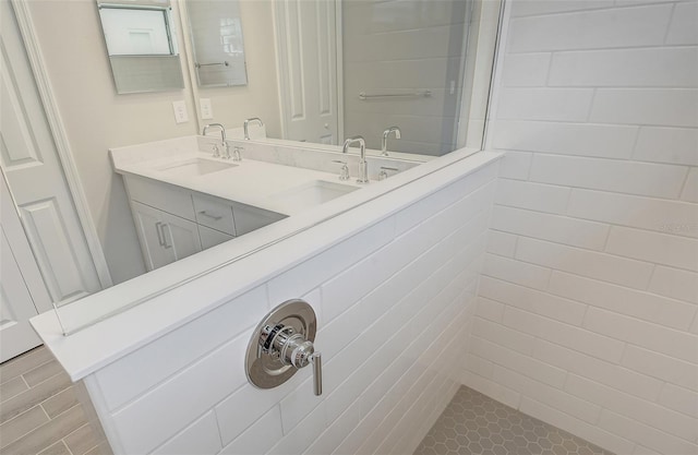 bathroom with vanity and tiled shower