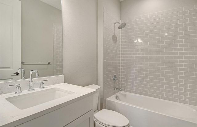 full bathroom with toilet, tiled shower / bath, and vanity