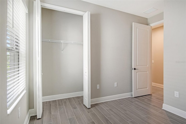 unfurnished bedroom featuring light wood-type flooring and a closet