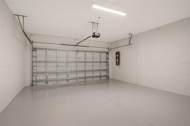 garage with a garage door opener and electric panel