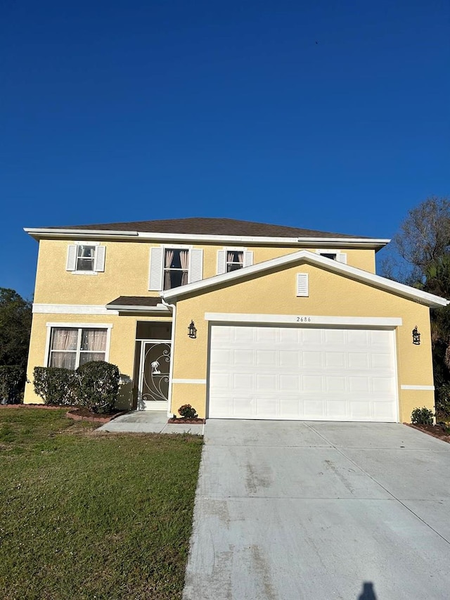 view of front of property with a front lawn and a garage