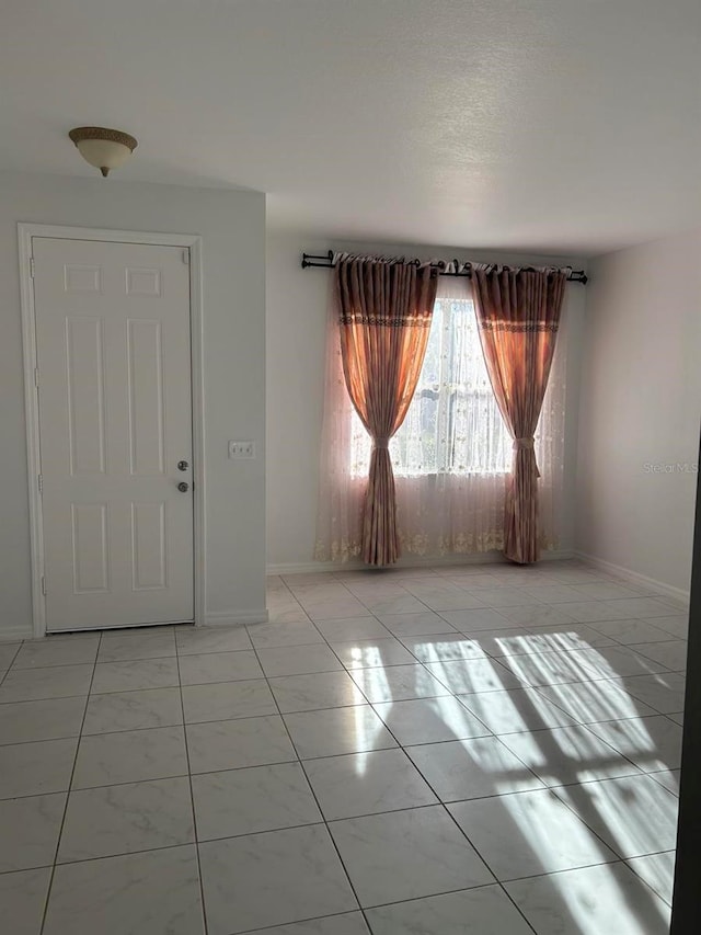 empty room with light tile flooring