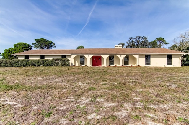 ranch-style home featuring a front yard