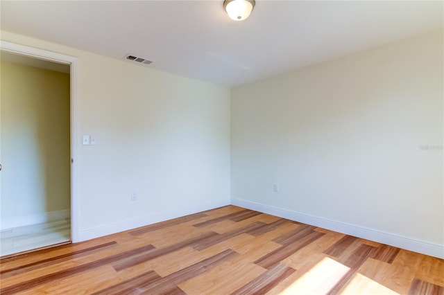 unfurnished room with light hardwood / wood-style floors