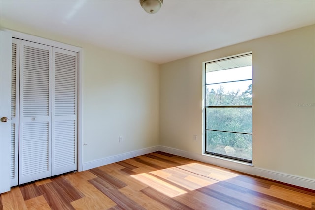 unfurnished bedroom featuring a closet and light hardwood / wood-style flooring