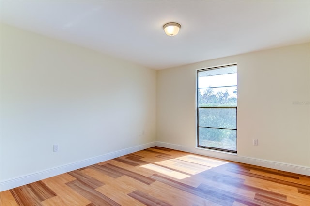 unfurnished room featuring plenty of natural light and light hardwood / wood-style flooring